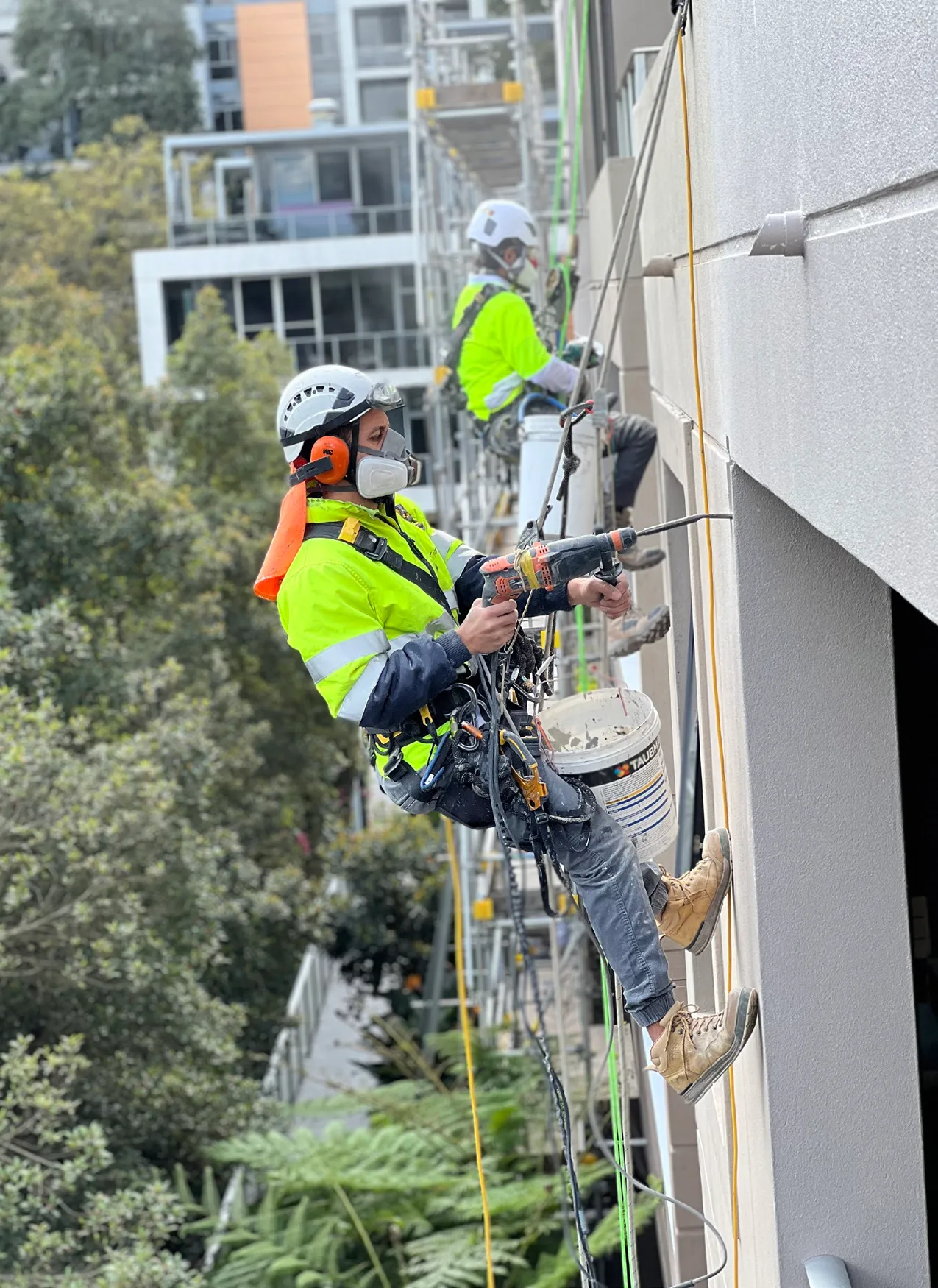 Omnia rope access technicians working on an apartment facade